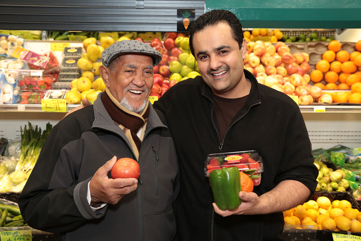 Men Holding Fruit at Grocery Store