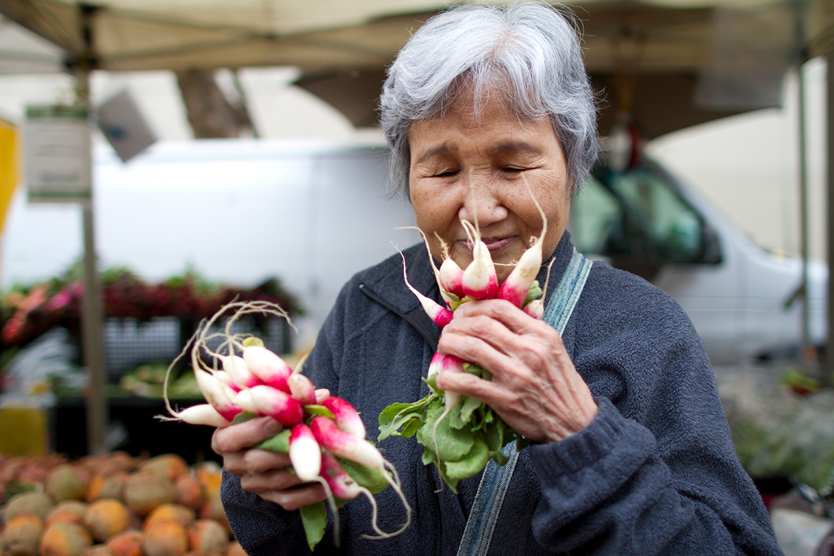 Woman Smelling Radishes