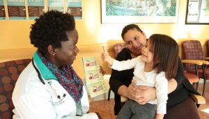Little Girl Giving Thumbs Up to Doctor